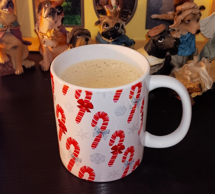 White mug with candy cane design in red and pink.